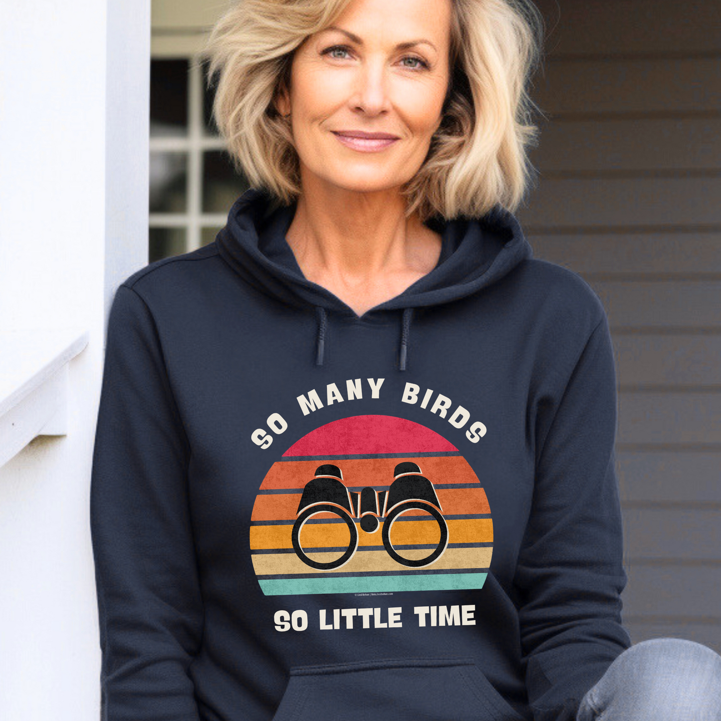 "So Many Birds, So Little Time" navy hoodie featuring a vintage-inspired sunset design with bold binocular art.